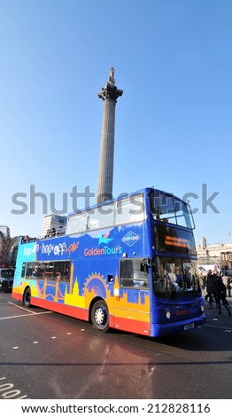 LONDON, UK - NOVEMBER 18, 2011: Tourist bus sightseeing the Nelson\'s Column in Trafalgar Square, London.