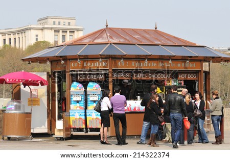 PARIS, FRANCE - MARCH 29, 2011: Tourists queue at fast food kiosk near Eiffel Tower in Paris