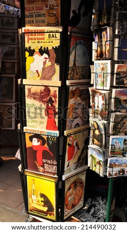 PARIS, FRANCE - MARCH 29, 2011: Various postcards from Paris for sale are displayed in front of souvenir shop