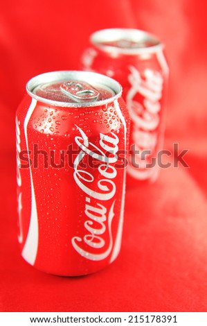 LONDON, UK - FEBRUARY 27, 2011: Detail of fresh Coca Cola can on red background (illustrative editorial)