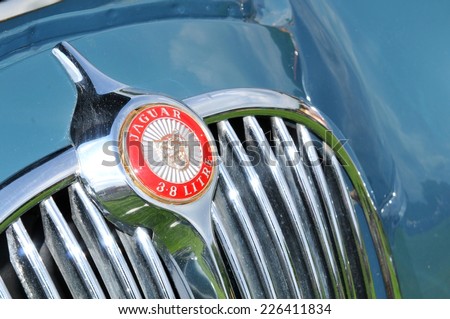 NOTTINGHAM, UK - JUNE 1, 2014: Close up of logo a vintage Jaguar car for sale in Nottingham, England.