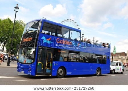 LONDON, UK - JULY 9, 2014: Tourists sightseeing London Eye in central London from a tour bus.