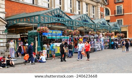 LONDON, UK - JULY 9, 2014: Tourists visit the Covent Garden market, important commercial landmark in central London