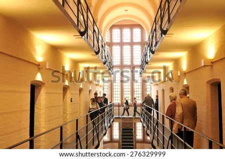 Lincoln, UK - April 9, 2015: Tourists visit medieval prison inside Lincoln Castle, a major castle constructed in Lincoln, East Midlands, England during the late 11th century by William the Conqueror.