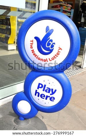 NOTTINGHAM, UK - APRIL 01, 2015: Close up of blue National lottery sign in front of shop showing its crossed fingers logo.