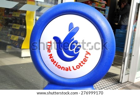 NOTTINGHAM, UK - APRIL 01, 2015: Close up of blue National lottery sign in front of shop showing its crossed fingers logo.