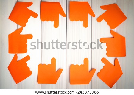 Stickers in the shape of a hand on a wooden background. Sticker hand. Background from boards.