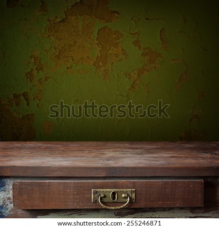 empty wooden table with a box against a wall. template.