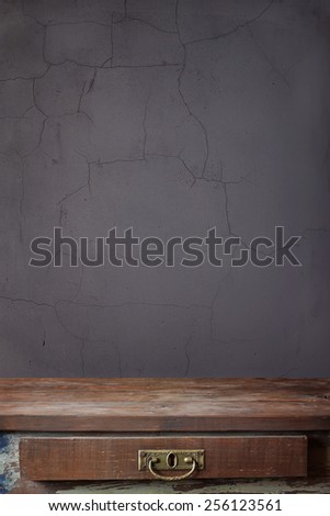 empty wooden table with a box against a wall / a template