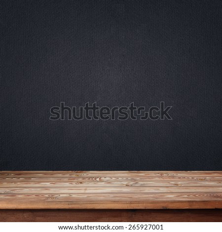 empty wooden table with a box against a dark wall