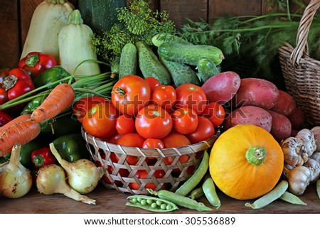 Still life with vegetables: tomato, carrots, pepper, potatoes, onions, vegetable marrow, garlic, cucumber, pumpkin, fennel, peas. Vegetables close up.