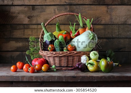 Basket with vegetables: vegetable marrow, pumpkin, eggplant, pepper, carrots, beet, cucumbers and tomatoes. Vegetables in a basket.