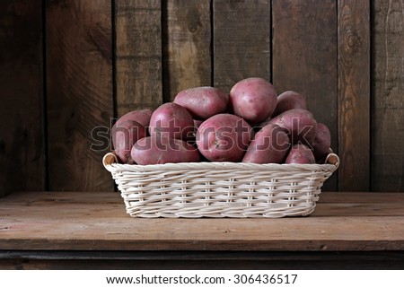 Still life with potatoes in a basket. Vegetables close up.