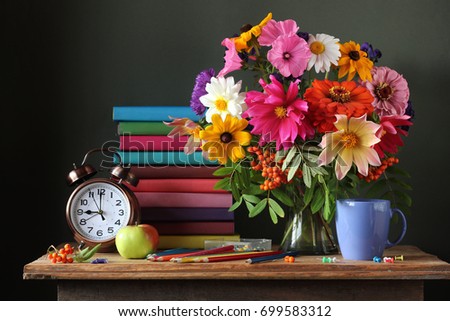 Back to school. September 1, knowledge day. The teacher\'s day. Still life with autumn bouquet, alarm clock and books. Education. The beginning of the school year.