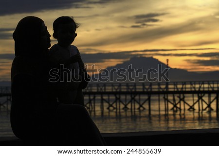 silhouette mother and child sunset background