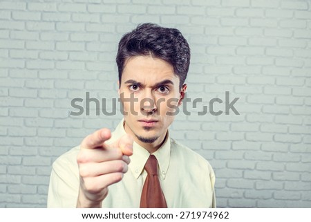 Young man pointing at you