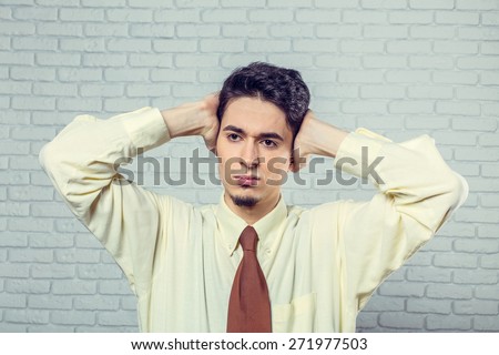 Young man covering ears
