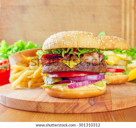 Double cheeseburger on wood stand