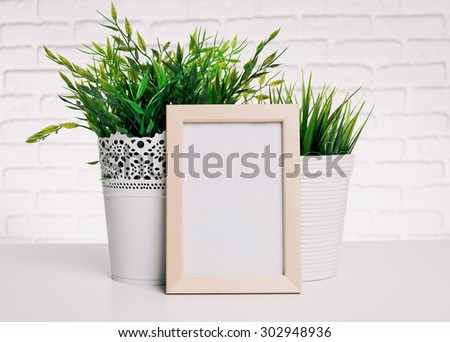 Blank small wooden photo frame and house plants