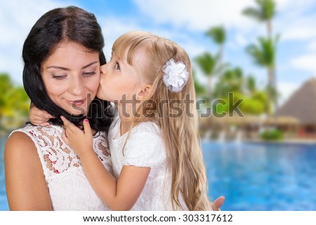 Mother and daughter kissing