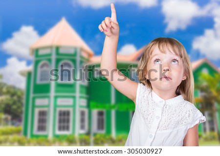 Little girl playing outside the house