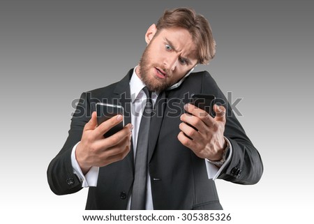 Busy businessman talking several phones same time