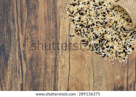 A bag of different types of rice dropped over a floor