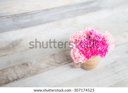 Pink Carnation fresh flowers in vase on wood backgrounds