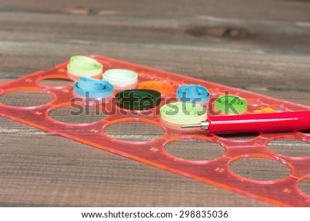 Bright colored background items for quilling (paper, pen, ruler)