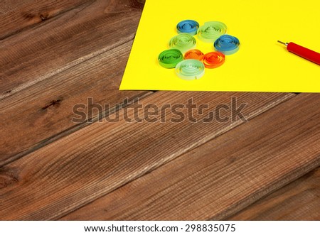 Bright colored background items for quilling (paper, pen, ruler)