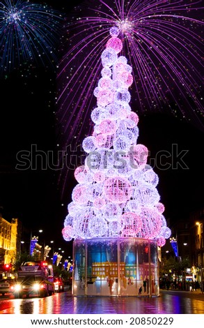 Colorful fireworks and Christmas tree on the streets of Dublin at night.