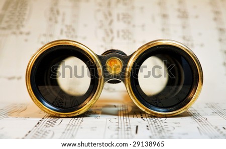 Old theater binoculars over classical music scores.