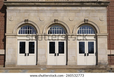 A large three door entrance to a school.