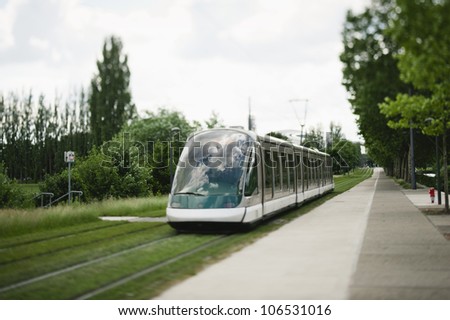 Modern tramway passing near the European Parliament in strasbourg, France. Tilt shift lens used to accent the moving tramway and to emphasize the motion.