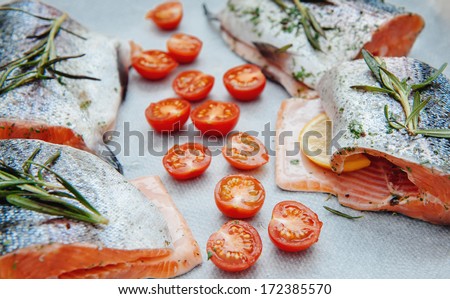 Fresh salmon with spices and cherry tomato ready to go to owen