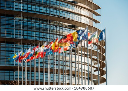 The European Parliament building in Strasbourg, France with flags waving on a spring evening