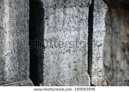 Roman tomb plates with latin inscription in ancient cemetery