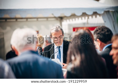 STRASBOURG, FRANCE - APRIL 14, 2014: Roland Ries mayor of Strasbourg ending his speech citizens in Place Kleber, Strasbourg, France. Mr Reis (socialist party) was re elected mayor on March 30, 2014