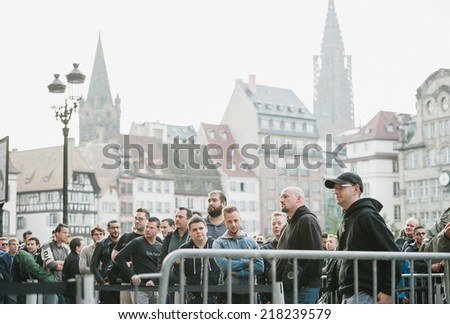 STRASBOURG, FRANCE - SEPTEMBER 19, 2014: Customers wait in line outside in front of the Apple Inc. store during the sales launch of the iPhone 6 and iPhone 6 Plus in Europe, on Friday, Sept. 19, 2014