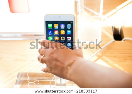 PARIS, FRANCE - SEPTEMBER 20, 2014: Hand holding a iPhone 6 Plus during the sales launch of the latest Apple Inc. smartphones at the Apple store in Paris, France