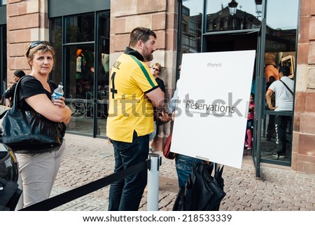 PARIS, FRANCE - SEPTEMBER 20, 2014: People wait in special line to get their reserved pre-ordered iPhones 6 on September 20