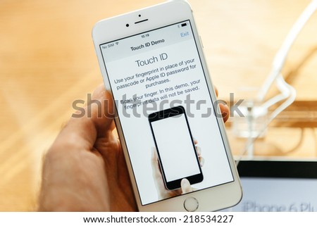 PARIS, FRANCE - SEPTEMBER 20, 2014: Hand holding a Apple iPhone 6 Plus displaying the new Touch Id App with  fingerprint option during the sales launch of the latest Apple Inc. smartphones