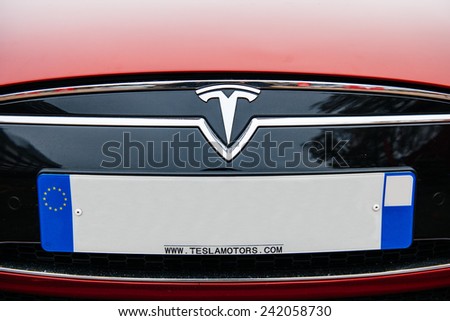 PARIS, FRANCE - NOVEMBER 29, 2014: The Tesla Motors Inc. badge logo and plate empty numbers are seen below the hood of the Model S electric vehicle displayed at the company\'s showroom in Paris, France