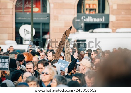 STRASBOURG, FRANCE - 11 JAN, 2015:  People hold placards reading \'Je suis Charlie\' during a unity rally (Marche Republicaine) where some 50000 took part in tribute three-day killing spree in Paris