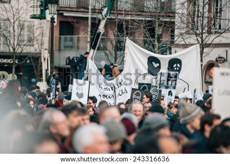 STRASBOURG, FRANCE - 11 JAN, 2015:  People hold placards reading \'Je suis Charlie\' during a unity rally (Marche Republicaine) where some 50000  took part in tribute three-day killing spree in Paris