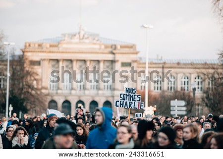 STRASBOURG, FRANCE - 11 JAN, 2015:  People hold placards reading \'Je suis Charlie\' during a unity rally (Marche Republicaine) where some 50000  took part in tribute three-day killing spree in Paris