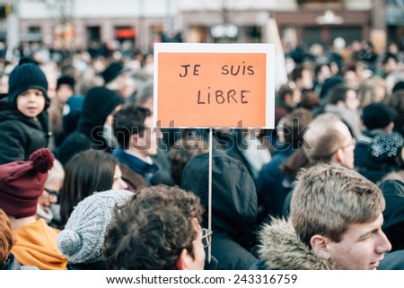 STRASBOURG, FRANCE - 11 JAN, 2015:  People hold placards reading \'I am free\' during a unity rally (Marche Republicaine) where some 50000  took part in tribute three-day killing spree in Paris