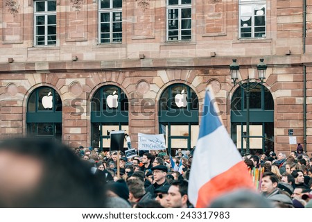 STRASBOURG, FRANCE - 11 JAN, 2015: People hold placards reading \'Don\'t touch my Charlie\' during a unity rally (Marche Republicaine) where 50000  took part in tribute three-day killing spree in Paris