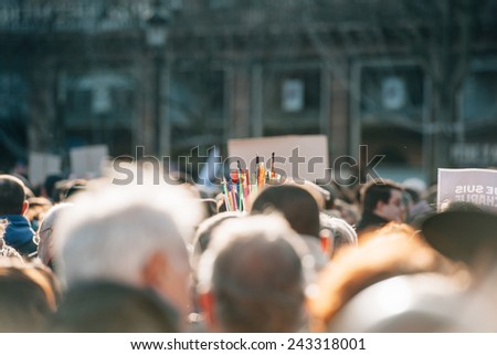 STRASBOURG, FRANCE - 11 JAN, 2015:  People hold bouquet of pencils during a unity rally (Marche Republicaine) where some 50000 people took part in tribute three-day killing spree in Paris