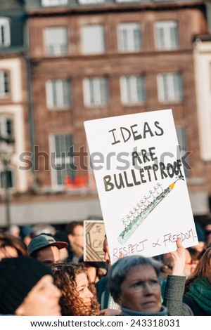 STRASBOURG, FRANCE - 11 JAN, 2015: People hold placards reading \'Ideas are bulletroof\' during a unity rally (Marche Republicaine) where some 50000 took part in tribute three-day killing spree in Paris